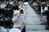 Limited numbers of fans watch in the Fuji International Speedway during the men's cycling road race at the 2020 Summer Olympics, Saturday, July 24, 2021, in Oyama, Japan. (AP Photo/Thibault Camus)