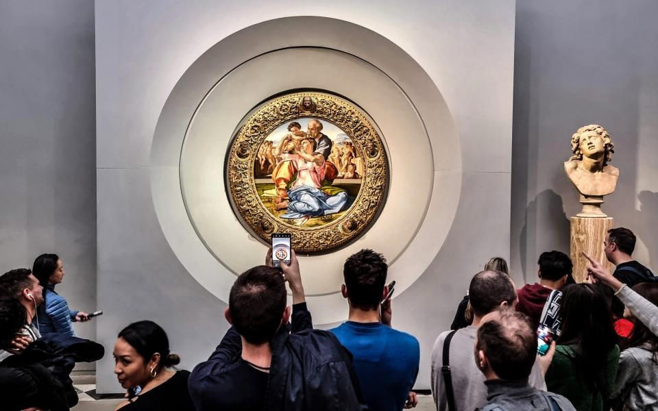 Visitors photograph Michelangelo's Doni Tondo