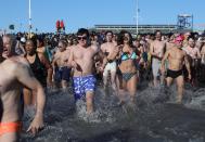 <p>Participants rush in the water during a polar bear plunge at the beach in Coney Island, Brooklyn on Jan. 1, 2018. New Yorkers took part in new year’s day swim with temperature standing at -7 degrees Celsius. (Photo: Atilgan Ozdil/Anadolu Agency/Getty Images) </p>