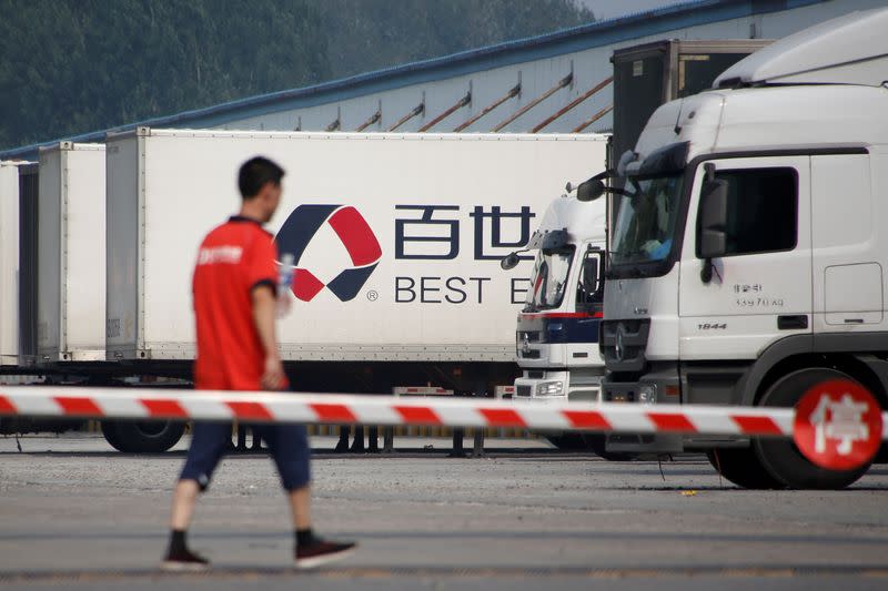 FILE PHOTO: A man walks in the compound of a distribution hub of the Chinese logistics company Best Inc in Beijing