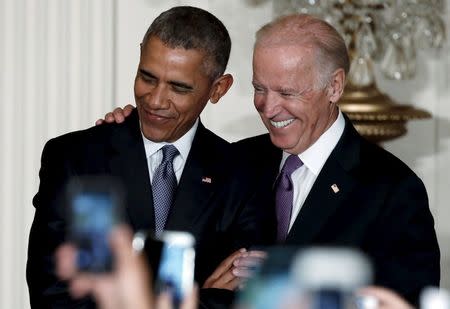 U.S. President Barack Obama (L) and Vice President Joe Biden participate in a reception for the 25th anniversary of the White House Initiative on Educational Excellence for Hispanics at the White House in Washington, October 15, 2015. REUTERS/Jonathan Ernst