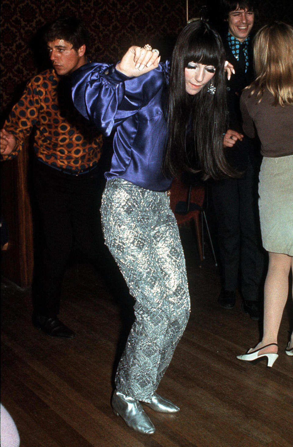 <p>Cher worked this glittery trousers and false eyelashes look like a pro some 50 years ago. <i>[Photo: Rex]</i></p>