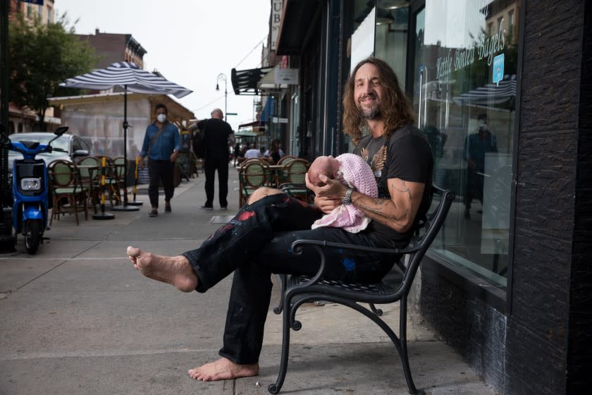 NEW YORK, NY - 8/7/21: Joseph Arthur, acclaimed singer, songwriter and visual artist for 25 years, poses for a portrait with his 4 day-old daughter Alessia Arthur on Saturday, August 7, 2021 in the Brooklyn borough of New York City. Arthur has paid the price of losing his manager, booking agent, publicist and label deal for speaking out about the Covid-19 vaccines, masking and vaccine passports on social media. (PHOTOGRAPH BY MICHAEL NAGLE / FOR THE TIMES)