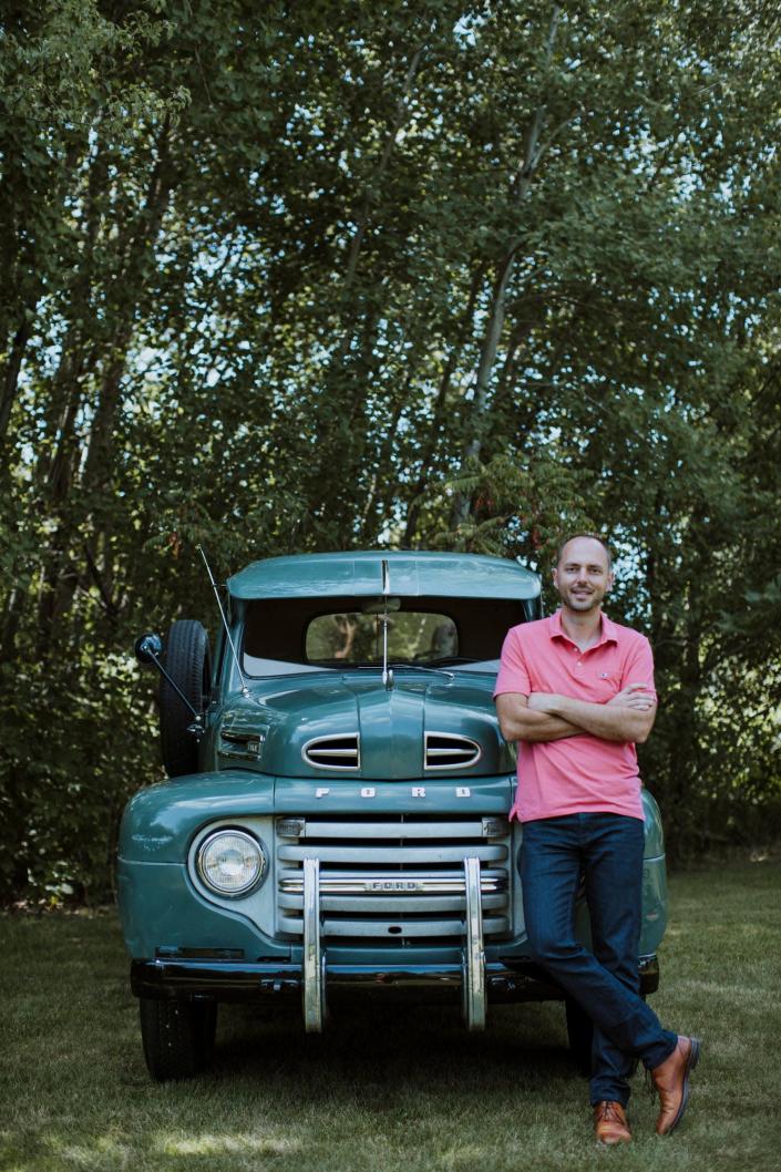 Jonathan Klinger, vice president of car culture at Hagerty, the world&#39;s largest insurer of collector vehicles, is pictured at his home in Traverse City on July 2020 with his unrestored 1950 Ford F-3.