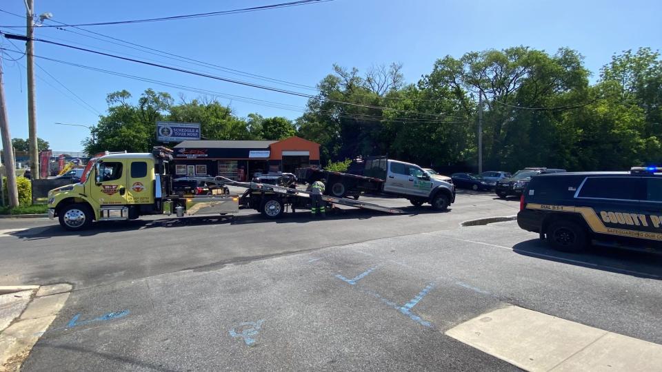 A tow truck loads up a vehicle that police say was used in a break-in at a Miller's Gun Center on Memorial Day.