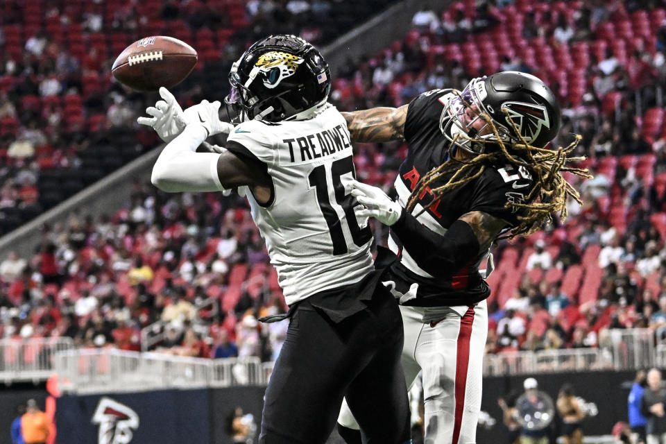 Jacksonville Jaguars wide receiver Laquon Treadwell (18) and Atlanta Falcons Mike Ford vie for the ball during the first half of an NFL football game, Saturday, Aug. 27, 2022, in Atlanta. (AP Photo/Danny Karnik)