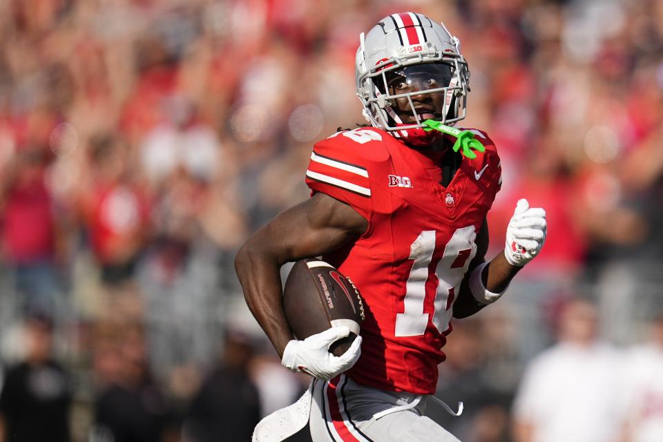 Sep 16, 2023; Columbus, Ohio, USA; Ohio State Buckeyes wide receiver Marvin Harrison Jr. (18) runs for a 75-yard touchdown catch during the first half of the NCAA football game against the Western Kentucky Hilltoppers at Ohio Stadium.