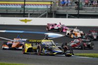 Colton Herta drives into the second turn on his way to winning the IndyCar Grand Prix auto race at Indianapolis Motor Speedway in Indianapolis, Saturday, May 14, 2022. (AP Photo/Michael Conroy)