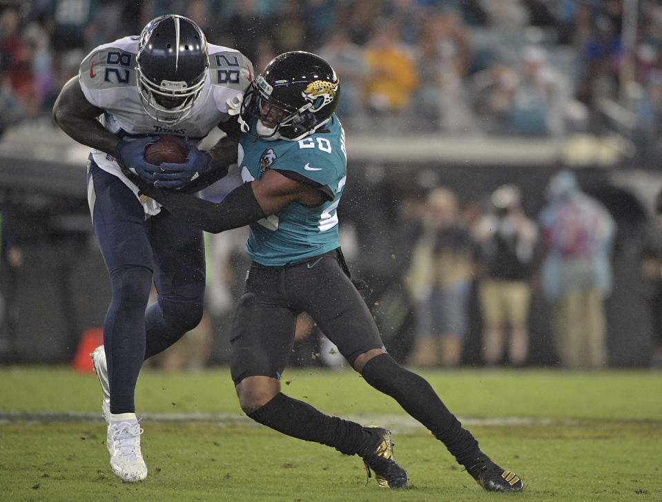 Jacksonville Jaguars cornerback Jalen Ramsey (20) stops Tennessee Titans tight end Delanie Walker (82) after a catch during the first half of an NFL football game Thursday, Sept. 19, 2019, in Jacksonville, Fla. (AP Photo/Phelan Ebenhack)