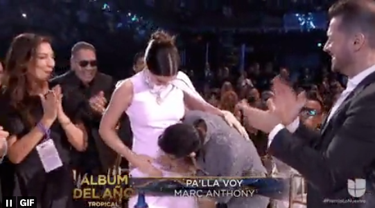 Marc Anthony kissing his wife's belly after winning tropical album of the year at the 2023 awards ceremony. (Univision)