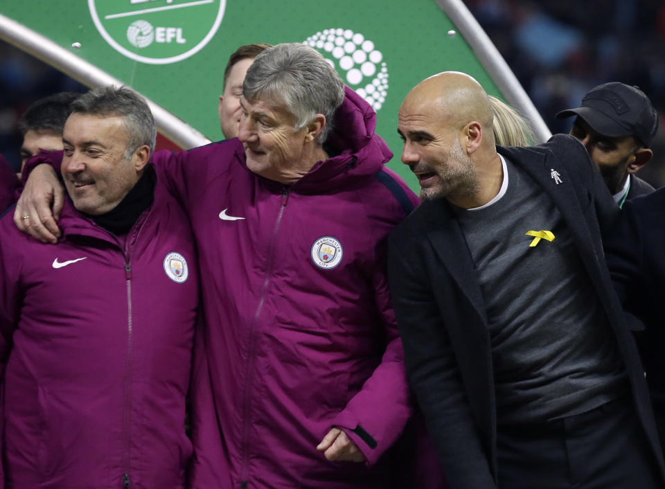 Manchester City’s manager Pep Guardiola, right, wears a yellow ribbon during the celebrations (AP Photo/Tim Ireland)