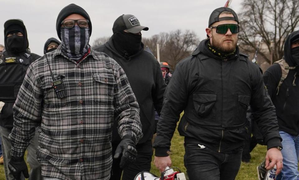 Proud Boys members Joseph Biggs, left, and Ethan Nordean walk toward the US. Capitol in Washington on 6 January 2021.