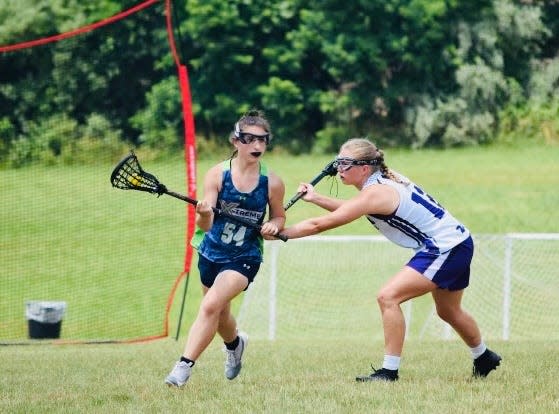 Mahwah’s Isabella Lotito (left) shields the ball while playing for the X-Treme LAX Factory club team.