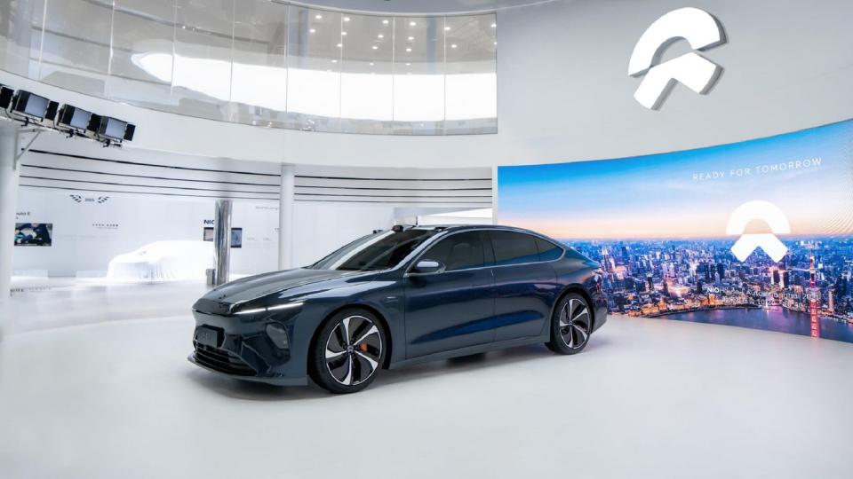 An all-electric Nio ET7 sedan displayed in a showroom.