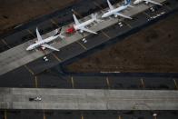 A truck drives by a line of grounded Boeing 737 MAX aircraft parked at Grant County International Airport in Moses Lake