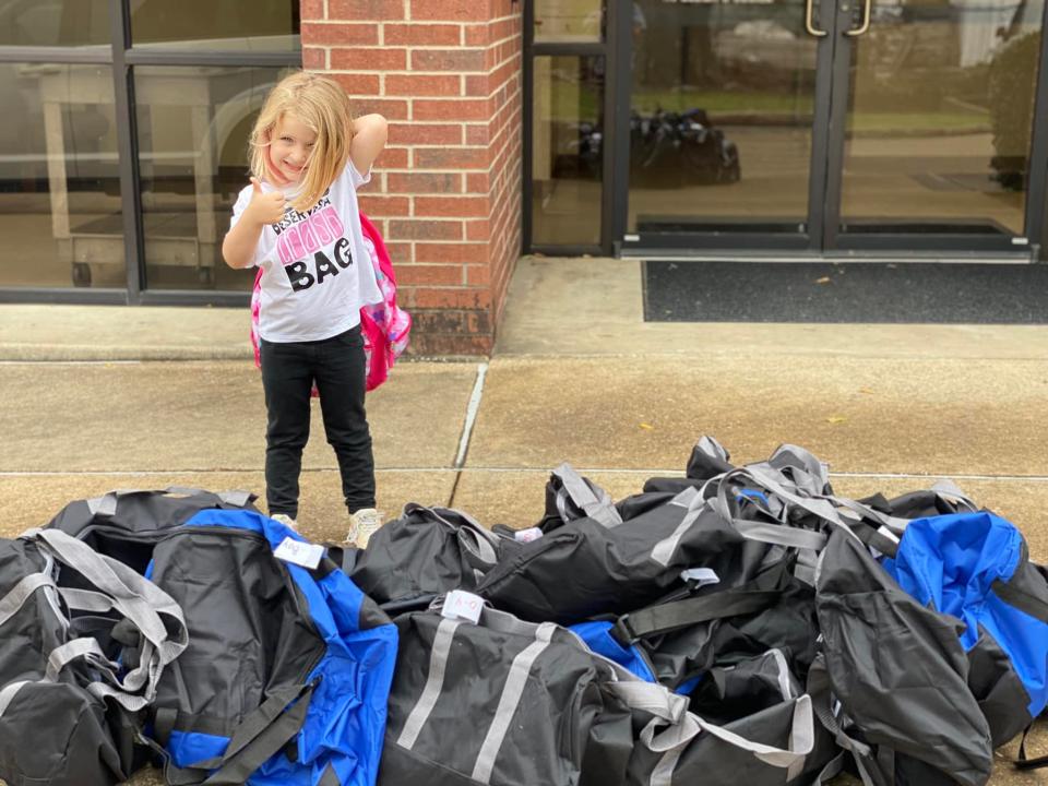 Diana Dawn Hatthorn, 4, daughter of Bags of Love founder Hallie Lively, helps her mother drop off 25 duffel bags and backpacks for foster children at the Lufkin office of Child Protective Services. As it is now, if a bag donated by a kind-hearted stranger isn’t available, some children being removed from a home have received just a garbage bag for their belongings.