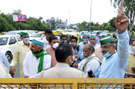 Members of the Bharatiya Kisan Union (BKU) Bhanu speak with police personnel at Sector 14A Noida Delhi border where the police placed barricades to stop them from proceeding towards Azadpur Mandi on September 23, 2020 in Noida, India. (Photo by Sunil Ghosh/Hindustan Times via Getty Images)