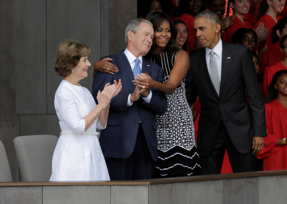 U.S. First Lady Michelle Obama hugs former U.S. President George W. Bush