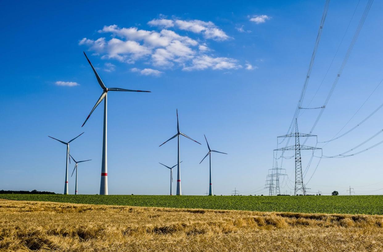 More wind turbines can increase renewable energy, but transmission lines are crucial, too. <a href="https://www.gettyimages.com/detail/news-photo/some-wind-power-plants-and-a-high-voltage-powerline-in-news-photo/1089383274" rel="nofollow noopener" target="_blank" data-ylk="slk:Frank Bienewald/LightRocket via Getty Images;elm:context_link;itc:0;sec:content-canvas" class="link ">Frank Bienewald/LightRocket via Getty Images</a>