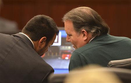 Defense attorney Cory Strolla (L) talks with Michael Dunn during the murder trial of Dunn for the shooting death of Jordan Davis at Duval County Courthouse in Jacksonville, Florida February 6, 2014. REUTERS/Bob Mack/Florida Times-Union/Pool