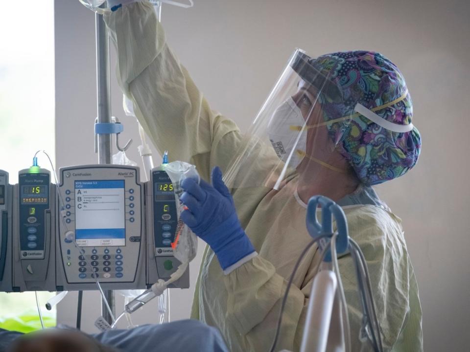 A nurse tends to a patient suspected of having COVID-19 in the intensive care unit at North York General Hospital in Toronto. Currently, 43 of the people hospitalized with COVID in Alberta are under the age of 18. Eight of them are in the ICU. (Evan Mitsui/CBC - image credit)