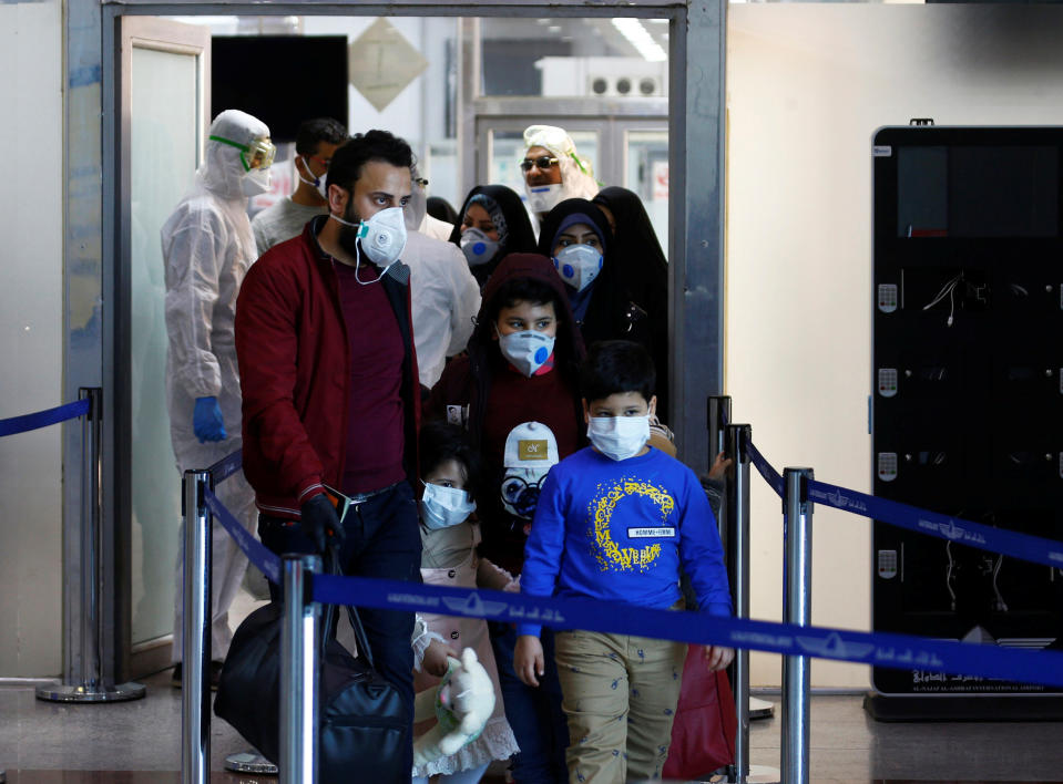 Passengers wearing protective face masks arrive from Iran, following an outbreak of the coronavirus, at Najaf airport, in the holy city of Najaf, Iraq February 26, 2020. Picture taken February 26, 2020.  REUTERS/Alaa al-Marjani