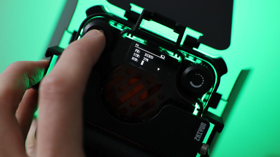 Zhiyun FIVERAY M20C LED panel lit up green and held in a hand