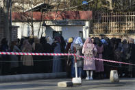 Afghan Students queue at one of Kabul University's gates, in Kabul, Afghanistan, Saturday, Feb. 26, 2022. Kabul University, among Afghanistan’s oldest and most revered institutions of higher education, reopened Saturday six months after the Taliban retook the country. There were new restrictions in place, however, including gender segregation and mandatory Islamic dress. (AP Photo/Hussein Malla)