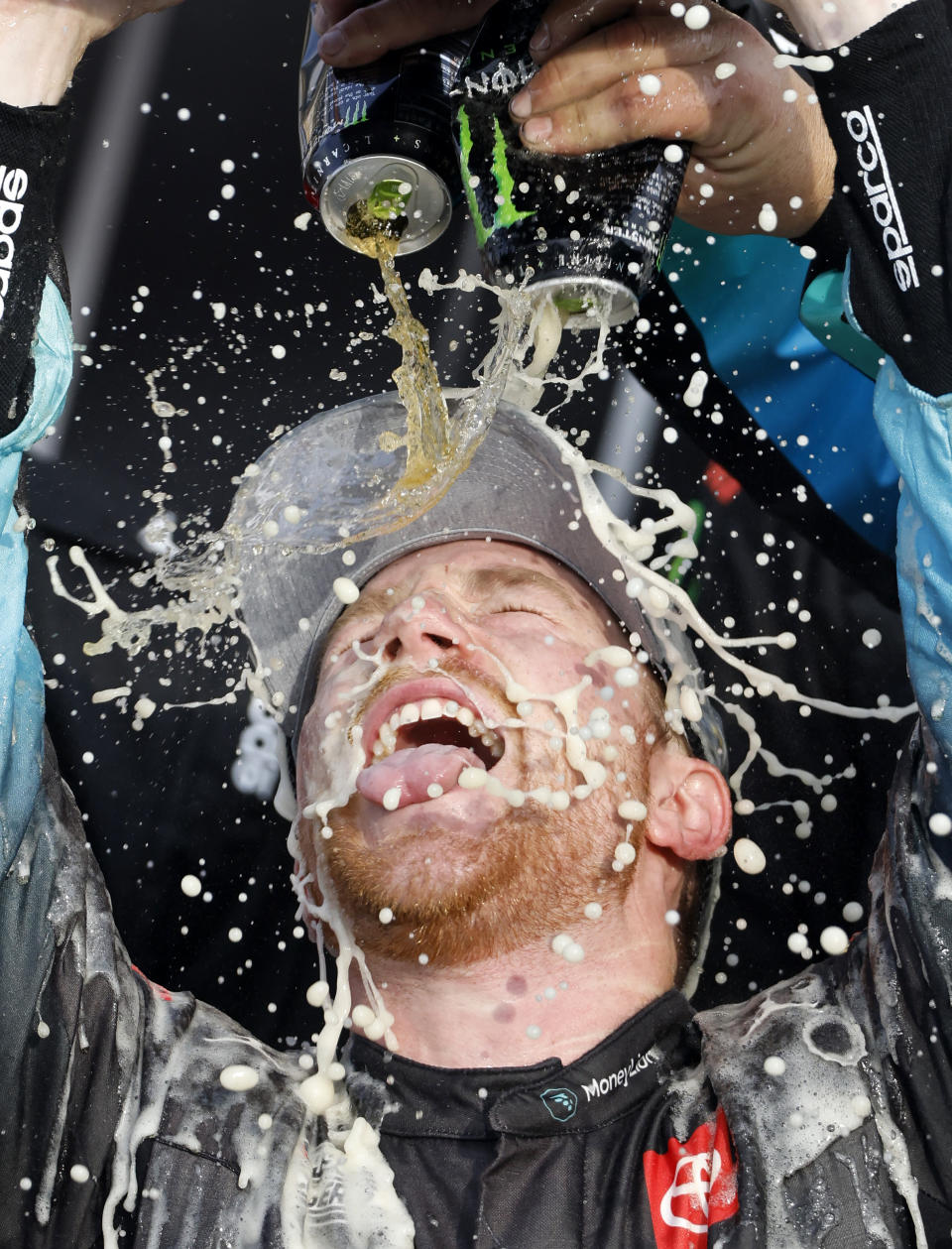 Tyler Reddick gets doused by his crew as he celebrates in Victory Lane after winning a NASCAR Cup Series auto race at Kansas Speedway in Kansas City, Kan., Sunday, Sept. 10, 2023. (AP Photo/Colin E. Braley)