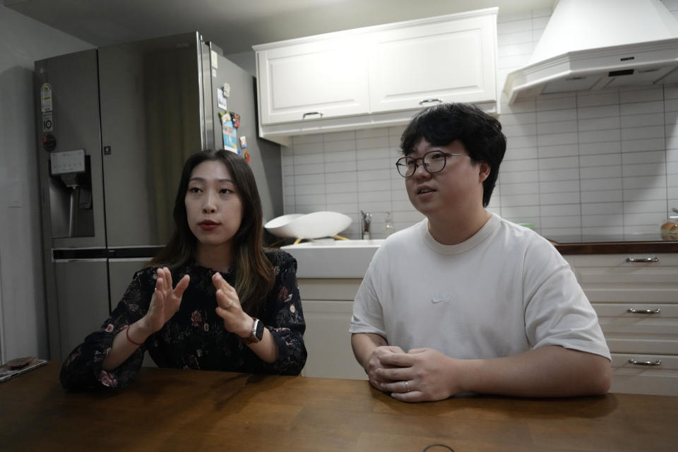 Yoo Young Yi speaks as her husband Jo Jun Hwi listens during an interview at their home in Seoul, South Korea, Sunday, Oct. 2, 2022. Many young people in South Korea have chosen not to marry or have children, citing a change of views toward a marriage and family life and uncertainty of their future. (AP Photo/Ahn Young-joon)