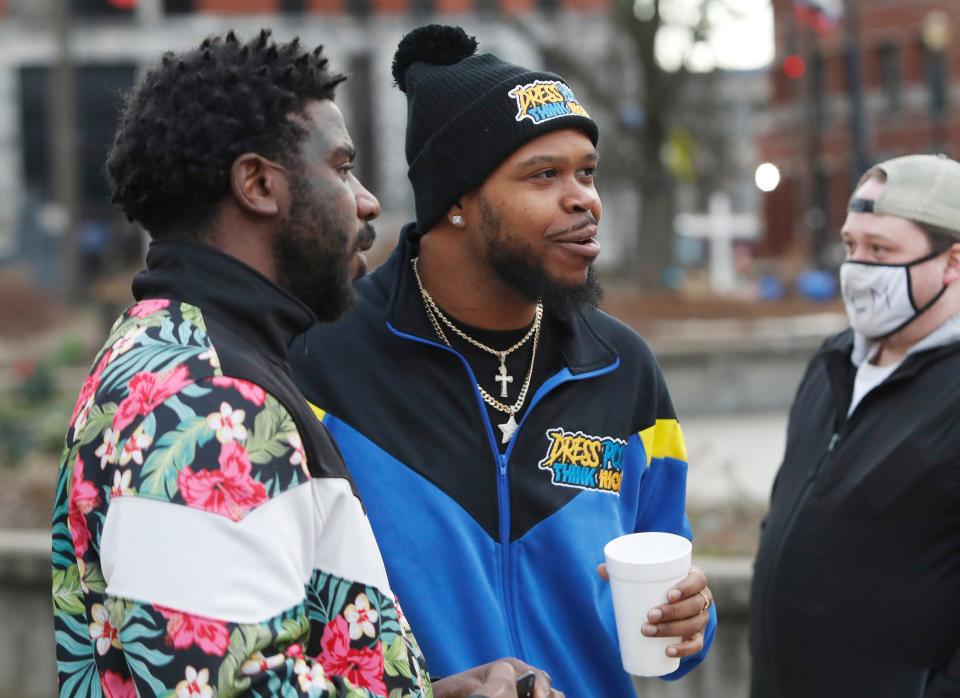 Kenneth Walker, center, the boyfriend of Breonna Taylor, spoke with protester Montez Jones, left, at Jefferson Square Park in Louisville, Ky., before a protest caravan on Feb. 25, 2021.