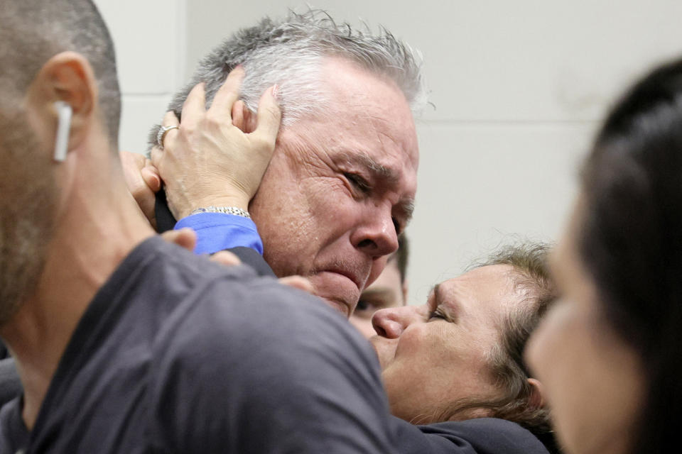 Former Marjory Stoneman Douglas High School School Resource Officer Scot Peterson embraces his wife, Lydia Rodriguez, after Peterson was found not guilty on all charges at the Broward County Courthouse in Fort Lauderdale, Fla., on Thursday, June 29, 2023. Peterson was acquitted of child neglect and other charges for failing to act during the Parkland school massacre, where 14 students and three staff members were murdered. (Amy Beth Bennett/South Florida Sun-Sentinel via AP, Pool)