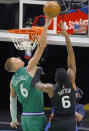 New York Knicks guard Elfrid Payton (6) has his shot blocked by Dallas Mavericks center Kristaps Porzingis (6) during the first half of an NBA basketball game, Friday, April 16, 2021, in Dallas. (AP Photo/Ron Jenkins)