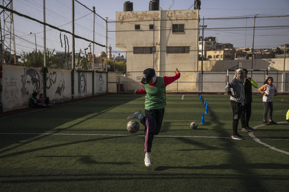 Palestinian girls practice during a soccer training session at the Beit Hanoun Al-Ahli Youth Club's ground in the northern Gaza strip, Tuesday, Oct. 29, 2022. Women's soccer has been long been neglected in the Middle East, a region that is mad for the men's game and hosts the World Cup for the first time this month in Qatar. (AP Photo/Fatima Shbair)