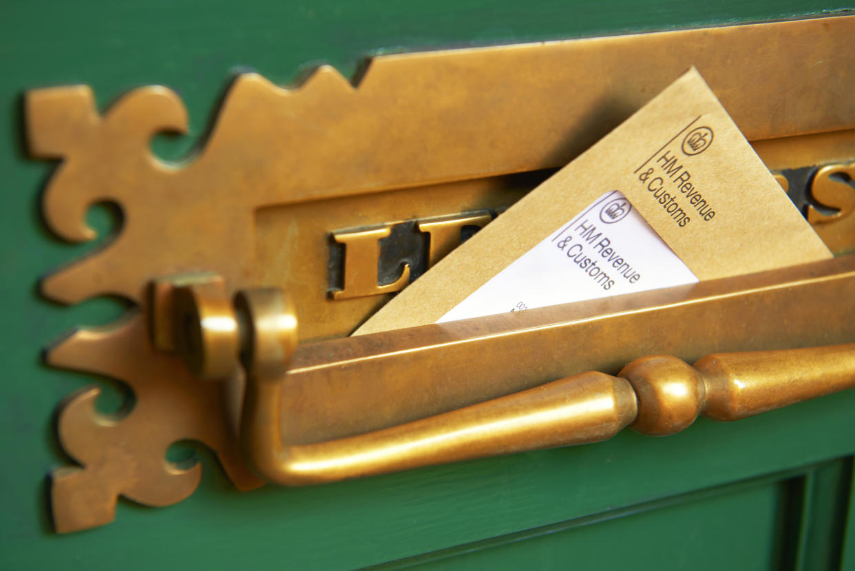 Photograph shows a front door letter box with HMRC envelope, Her Majestys Revenue and Customs (HMRC) reminding of the date that self-assessment tax returns need to be completed by self-employed companies and individuals. Photographed by Peter Dazeley, London, November 2020