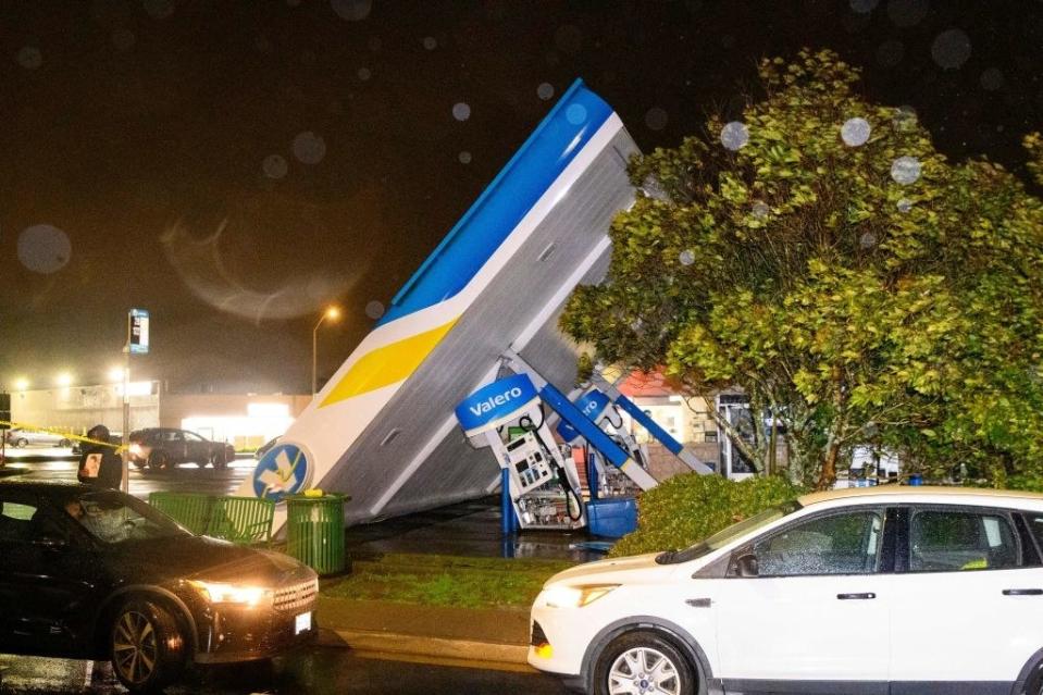 The large structure that covers the gas pumps has been blown onto its side, which has also bent the pumps sideways