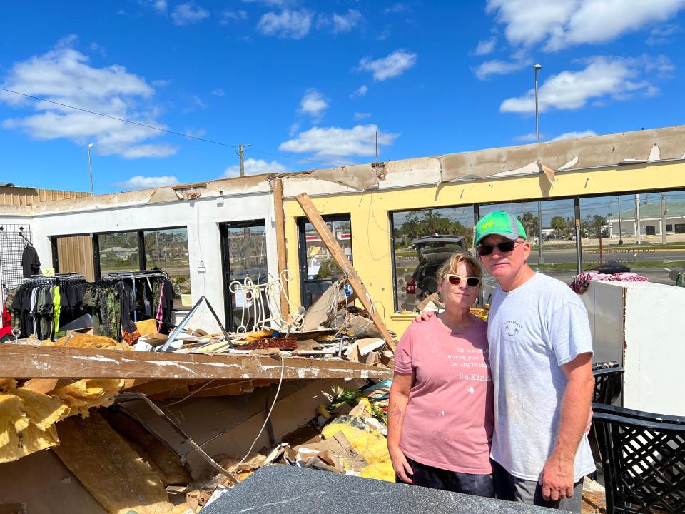 Teresa and Dave Karaffa inside their Englewood business, the Lemon Bay Soap Company, which was destroyed by Hurricane Ian. The roof of the business came completely off, with nothing overhead but blue sky.