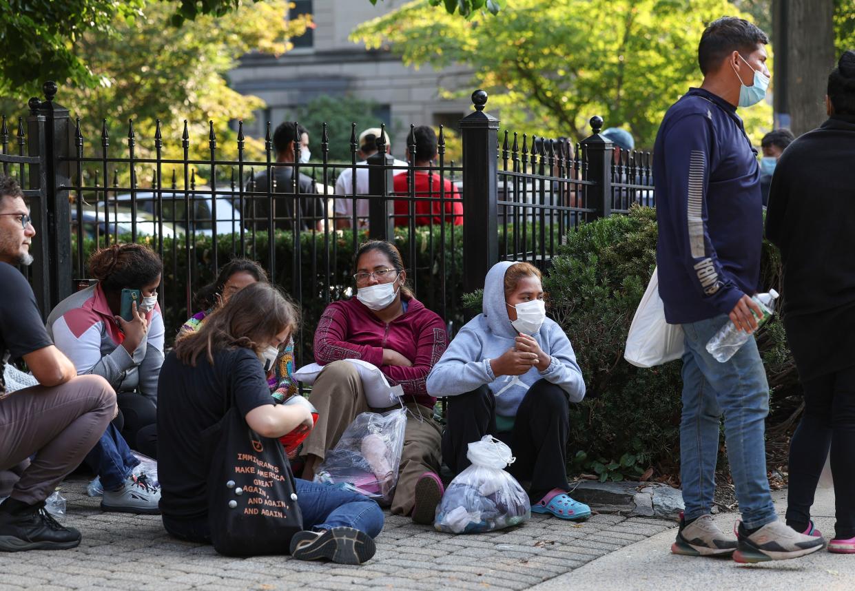 Migrants from Central and South America wait near the residence of Vice President Kamala Harris after being dropped off on Sept. 15, 2022 in Washington, D.C. 