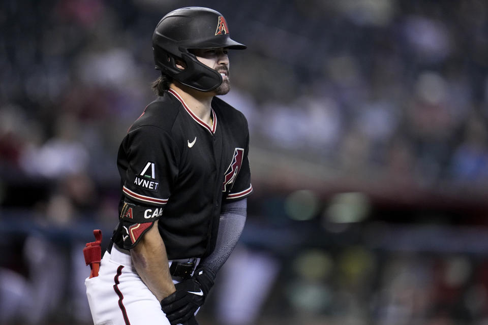 Arizona Diamondbacks' Corbin Carroll holds his right wrist after being hit by a pitch during the fourth inning of a baseball game against the Colorado Rockies, Wednesday, Sept. 6, 2023, in Phoenix. Carroll remained in the game. (AP Photo/Ross D. Franklin)