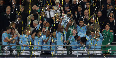 Soccer Football - Carabao Cup Final - Arsenal vs Manchester City - Wembley Stadium, London, Britain - February 25, 2018 Manchester City's Vincent Kompany lifts the trophy as they celebrate winning the Carabao Cup REUTERS/Darren Staples