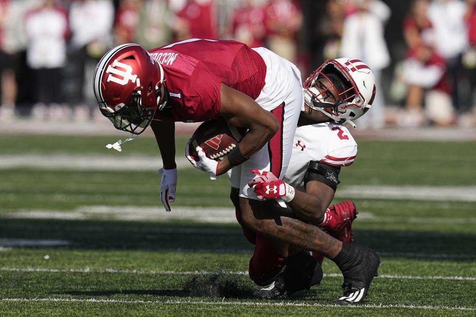 Indiana wide receiver Donaven McCulley (1) is tackled by Wisconsin cornerback Ricardo Hallman (2) during the first half of an NCAA college football game, Saturday, Nov. 4, 2023, in Bloomington, Ind. (AP Photo/Darron Cummings)