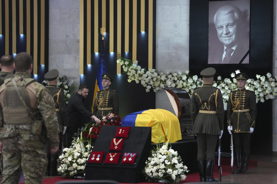 Ukrainian President Volodymyr Zelenskyy, center left, pays his respects at the funeral of Leonid Kravchuk, independent Ukraine's first president, during a farewell ceremony at the International Convention Center Ukrainian House, in Kyiv, Ukraine, Tuesday, May 17, 2022. Kravchuk led Ukraine to independence amid the collapse of the Soviet Union and served as its first president. He died on May 10 at the age of 88. (AP Photo/Evgeniy Maloletka)