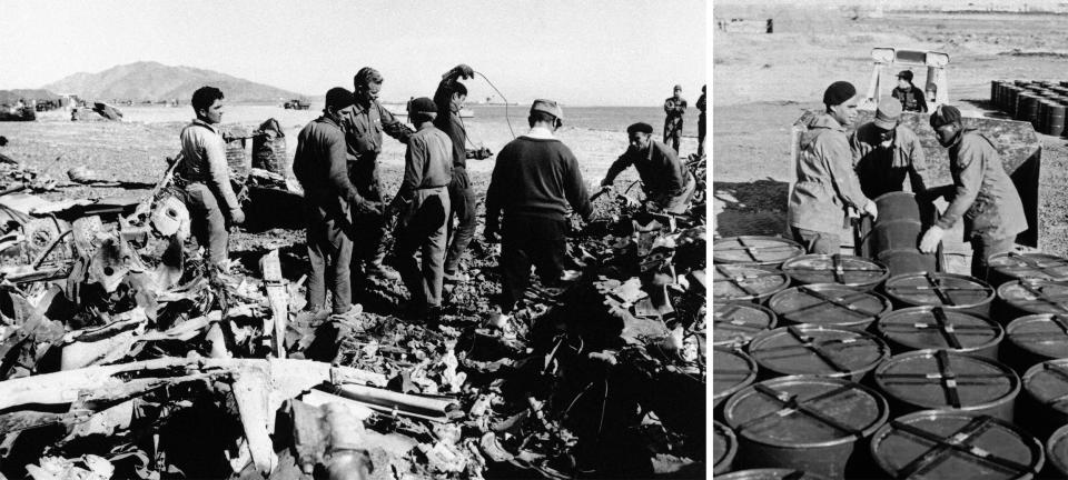 Workers sort through the wreckage and collect barrels of contaminated earth during the cleanup of an Air Force B-52 bomber carrying nuclear weapons that crashed off Palomares, Spain, in 1966. (AP)