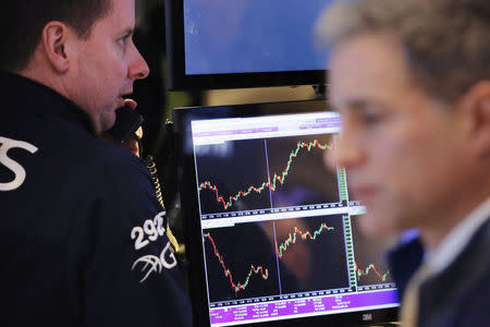 Traders work on the floor of the New York Stock Exchange (NYSE) shortly after the opening bell in New York, U.S., January 9, 2017. REUTERS/Lucas Jackson