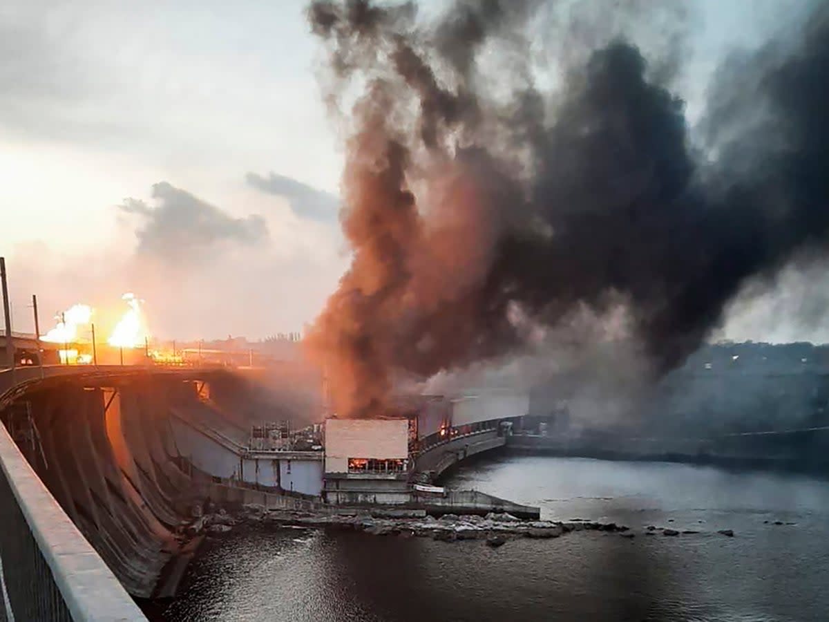 In this photo provided by Telegram Channel of Ukraine’s prime minister Denys Shmyhal, smoke and fire rise over the Dnipro hydroelectric power plant after Russian attack (AP)