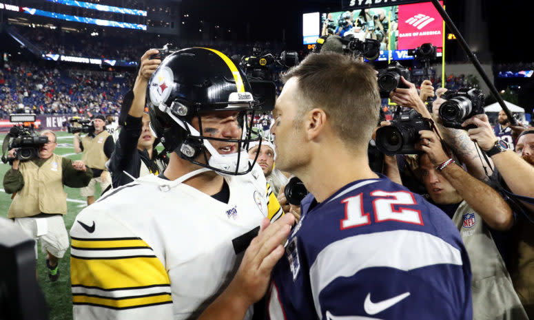 Ben Roethlisberger and Tom Brady shake hands on the field after a game.