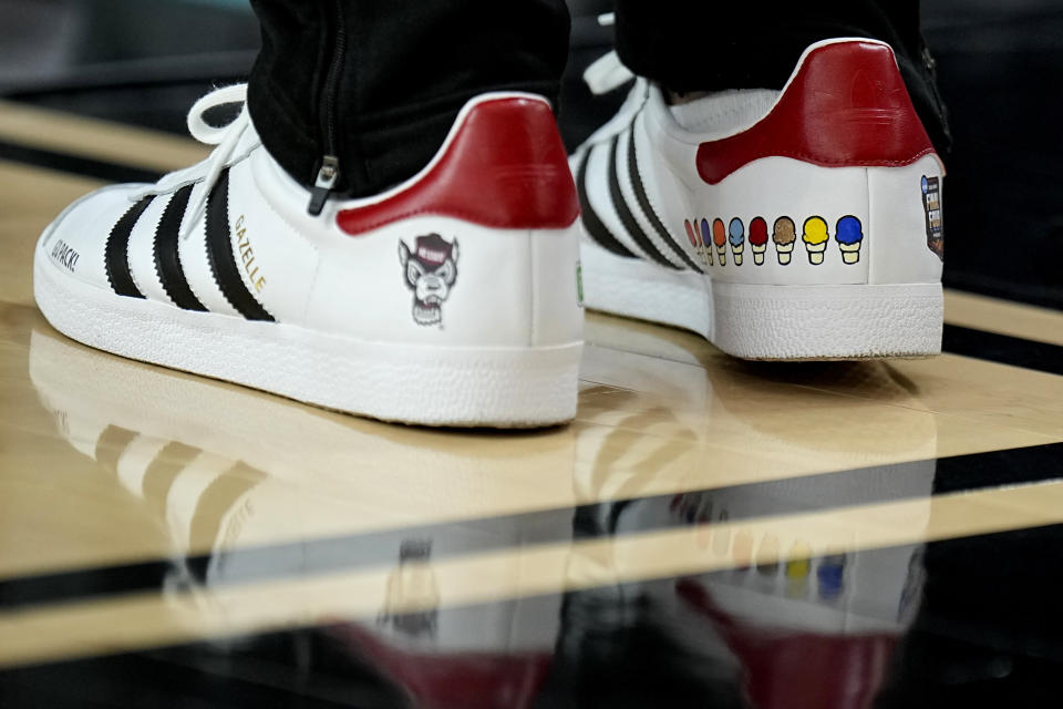 NC State head coach Kevin Keatts wears custom stitched shoes during practice ahead of a Final Four college basketball game in the NCAA Tournament, Friday, April 5, 2024, in Glendale, Ariz. North Carolina State plays Purdue. (AP Photo/Brynn Anderson )