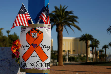 A sign is pictured at a makeshift memorial in the middle of Las Vegas Boulevard following the mass shooting in Las Vegas, Nevada, U.S., October 4, 2017. REUTERS/Chris Wattie