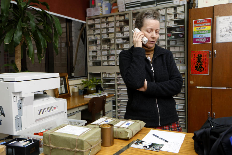 Karen Short, wife of the Australian missionary John Short, talks on the phone inside the Christian Book Room in Hong Kong Wednesday, Feb. 19, 2014. Short went to North Korea in a regular tour group last week with one other person, who returned to China on Tuesday and told the family Short had been questioned and arrested at his Pyongyang hotel on Sunday, according to a statement released by the family. (AP Photo/Kin Cheung)