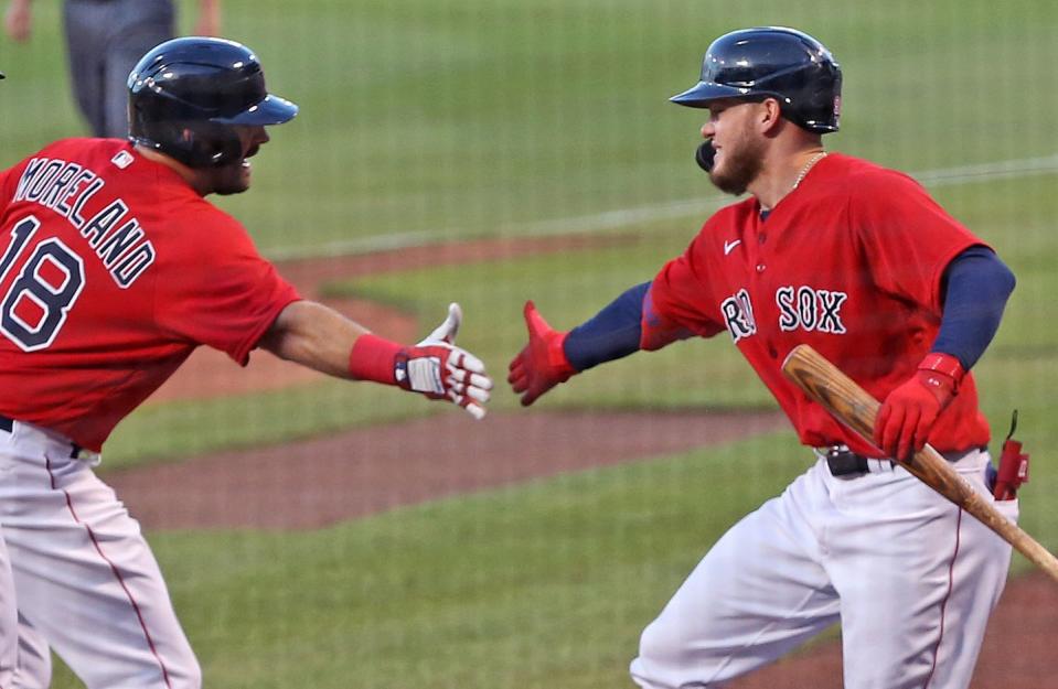 <p>Boston Red Sox Mitch Moreland, left, is greeted by teammate Alex Verdugo after he hit a first inning three-run home run. The Boston Red Sox host The Toronto Blue Jays in an exhibition baseball game at Fenway Park in Boston on July 21.</p>